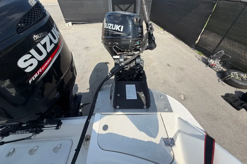 Slide: The Image of 2019 Hurricane SunDeck 2400 OB with Suzuki outboard motors, parked on pavement. - 74