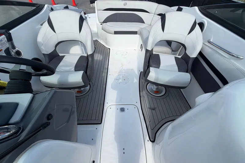 Slide: The Image of 2019 Hurricane SunDeck 2400 OB boat interior with white and gray seating. - 59