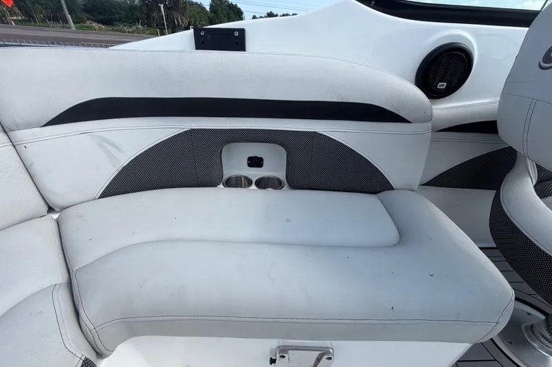 Slide: The Image of 2019 Hurricane SunDeck 2400 OB boat interior with white seating and cup holders. - 65