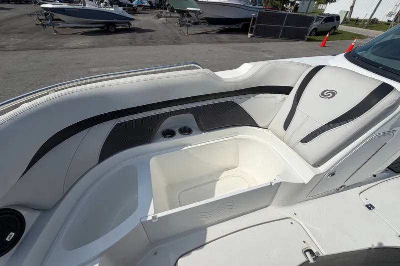 Slide: The Image of 2019 Hurricane SunDeck 2400 OB boat interior with seating and storage compartment. - 52