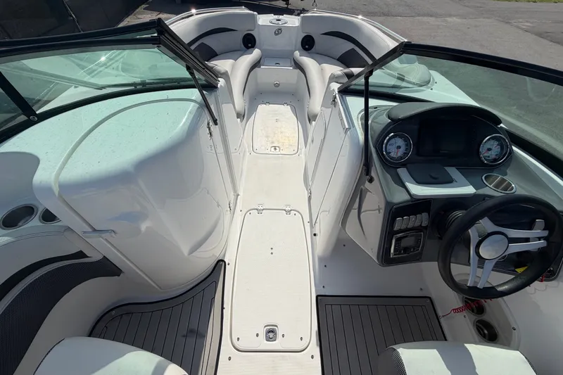 Slide: The Image of 2019 Hurricane SunDeck 2400 OB boat interior with steering wheel and seating area. - 35