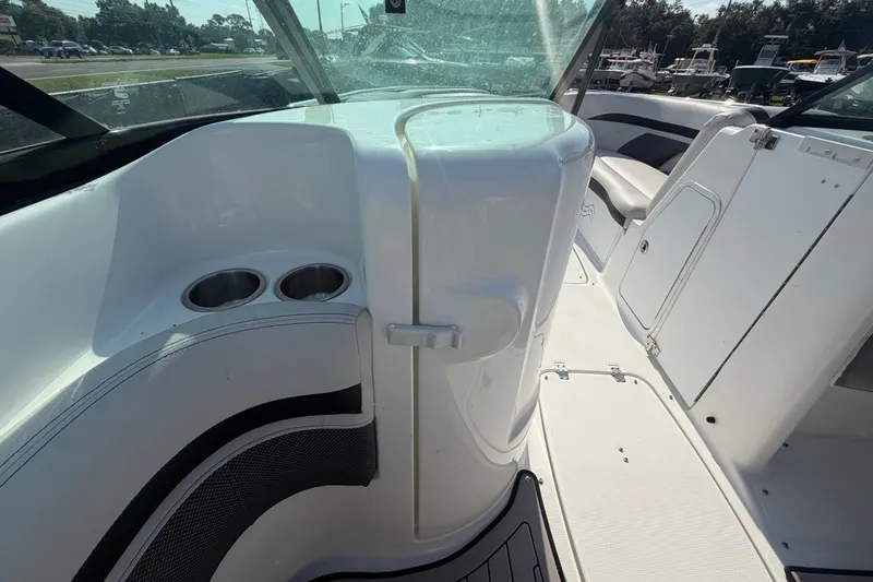 Slide: The Image of Interior view of 2019 Hurricane SunDeck 2400 OB boat, featuring seating and cup holders. - 23