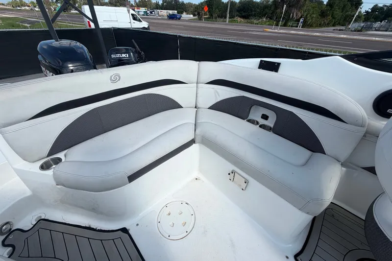 Slide: The Image of 2019 Hurricane SunDeck 2400 OB boat interior with white seating and Suzuki outboard motor. - 64