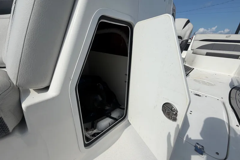 Slide: The Image of Open storage compartment on 2019 Hurricane SunDeck 2400 OB boat, showcasing interior space. - 57