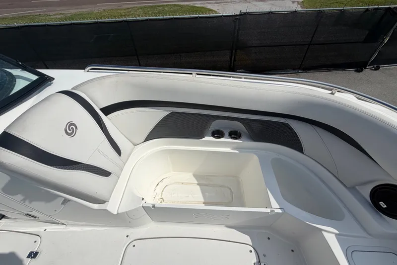 Slide: The Image of 2019 Hurricane SunDeck 2400 OB boat interior with white seating and storage compartment. - 45