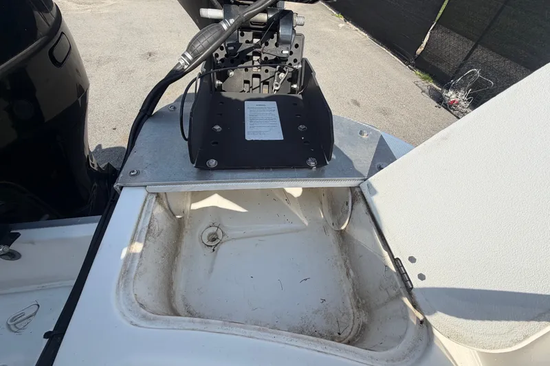 Slide: The Image of 2019 Hurricane SunDeck 2400 OB boat storage compartment with open lid and visible wiring. - 76