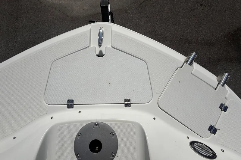 Slide: The Image of The image shows the bow deck of a 2019 Hurricane SunDeck 2400 OB with storage and mounts. - 49