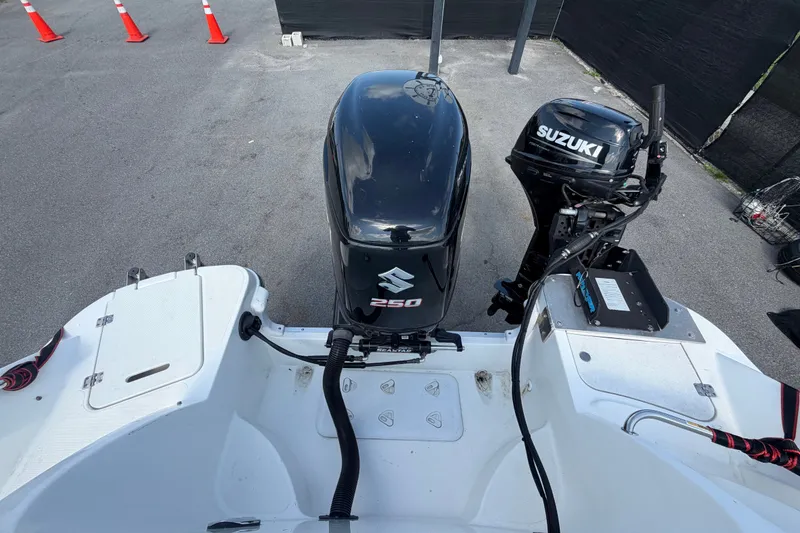 Slide: The Image of 2019 Hurricane SunDeck 2400 OB with Suzuki outboard motors, parked on pavement. - 72