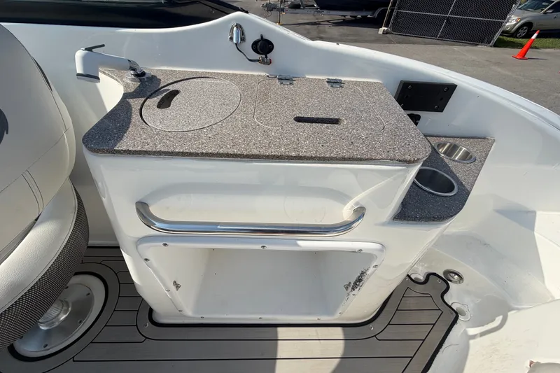 Slide: The Image of 2019 Hurricane SunDeck 2400 OB boat interior with sink and storage area. - 17