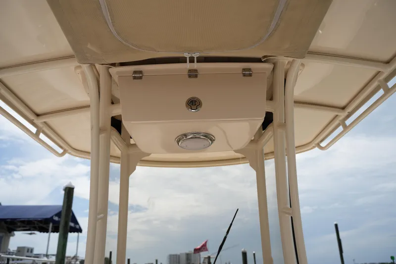 Slide: The Image of 2021 Grady-White 251 Coastal Explorer boat canopy and storage compartment under clear sky. - 25
