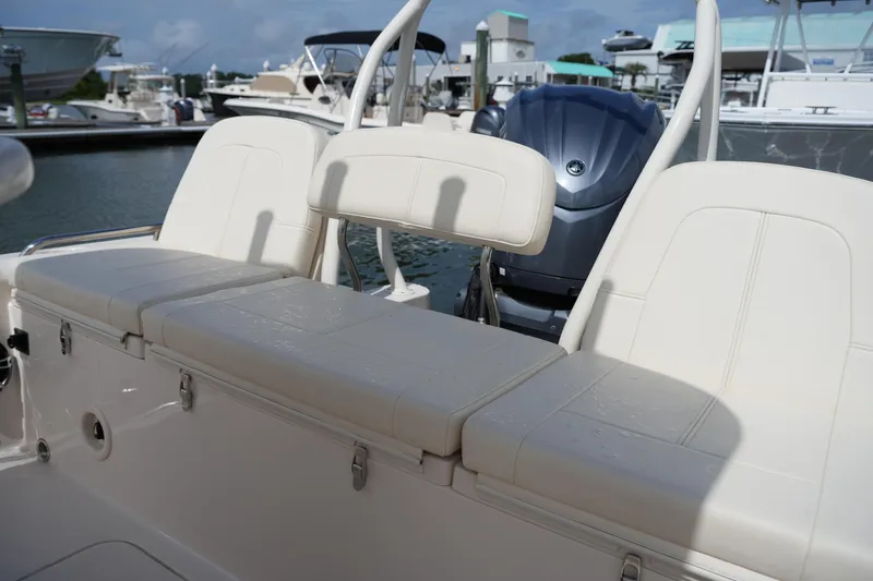 Slide: The Image of 2021 Grady-White 251 Coastal Explorer boat seating and engine at marina. - 13