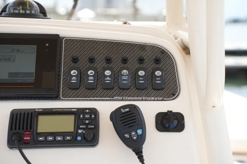 Slide: The Image of Control panel of 2021 Grady-White 251 Coastal Explorer boat with switches and communication device. - 21