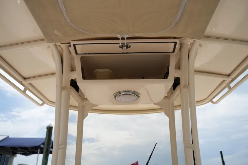 Slide: The Image of 2021 Grady-White 251 Coastal Explorer boat console with storage compartment and overhead light. - 26