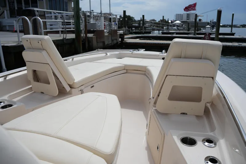 Slide: The Image of 2021 Grady-White 251 Coastal Explorer boat interior with comfortable seating at a marina. - 28