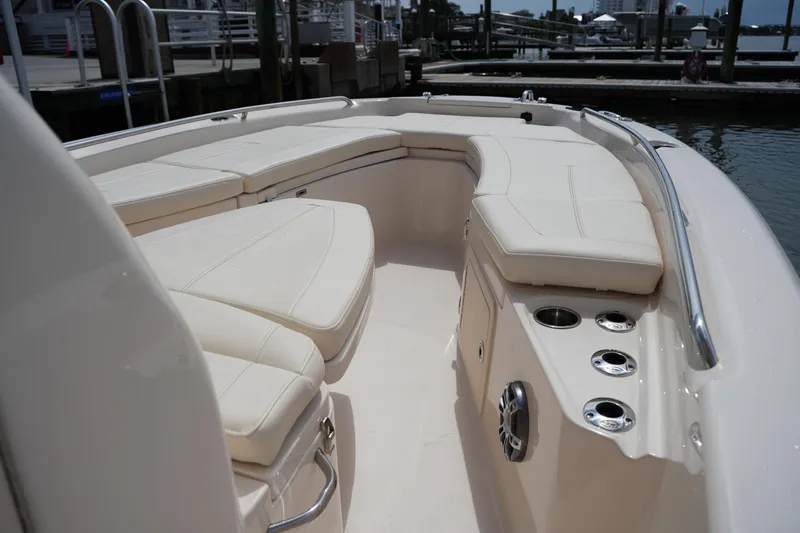 Slide: The Image of 2021 Grady-White 251 Coastal Explorer boat interior with cushioned seating and cup holders. - 27
