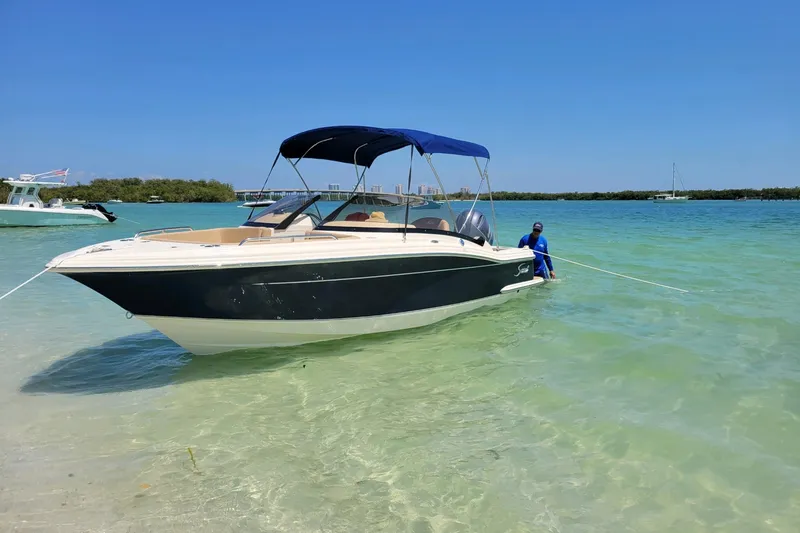 The Image of 2022 Scout 215 Dorado boat anchored in clear turquoise water under a sunny sky. - 0