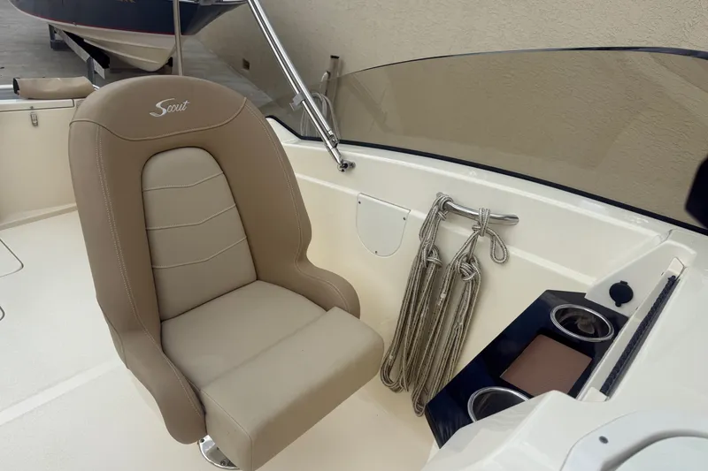 Slide: The Image of 2022 Scout 215 Dorado boat interior with beige seat, ropes, and cup holders. - 13