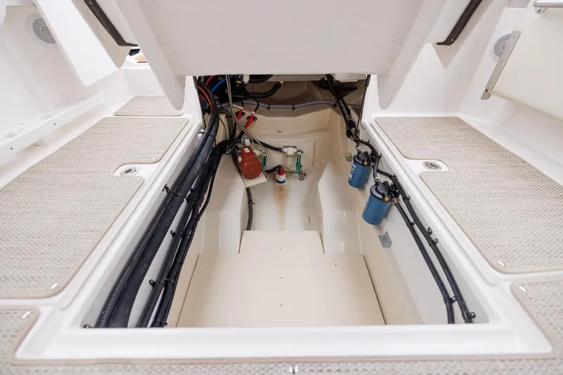 Slide: The Image of 2026 Ranger Tugs R-27 engine compartment, showcasing wiring and components. - 32