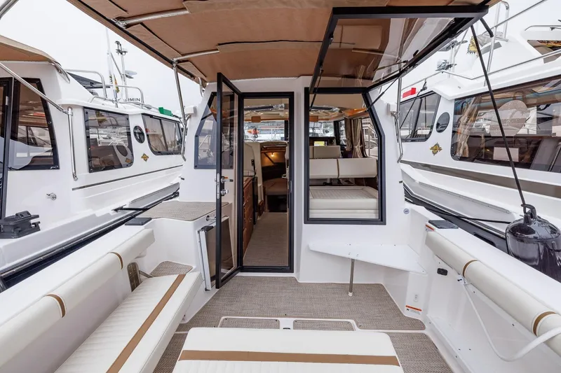Slide: The Image of 2026 Ranger Tugs R-27 boat interior, featuring spacious seating and modern design. - 16