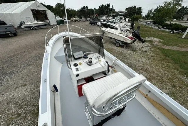 Slide: The Image of 1975 F L Tripp & Sons 18 Center Console boat in a marina with other vessels. - 5