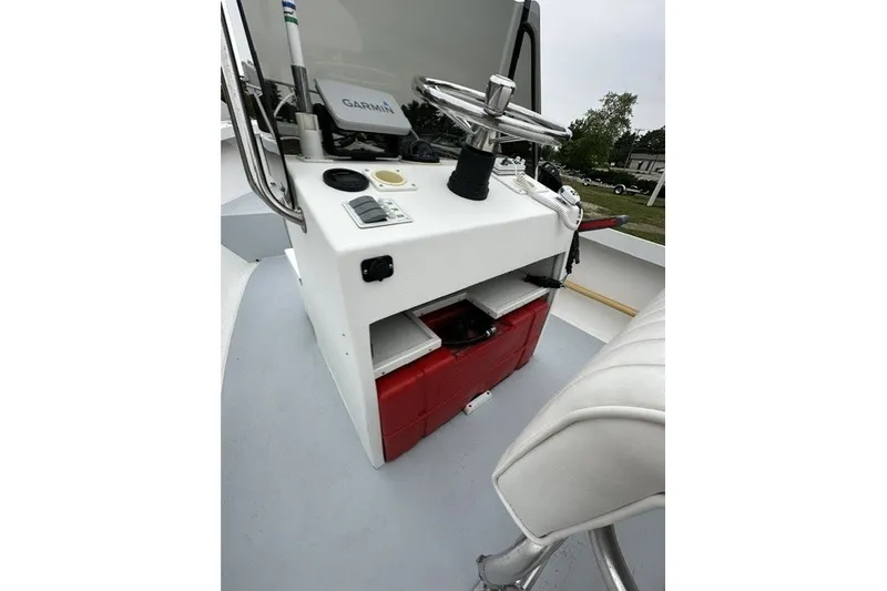 Slide: The Image of 1975 F L Tripp & Sons 18 Center Console boat interior with steering wheel and controls. - 17