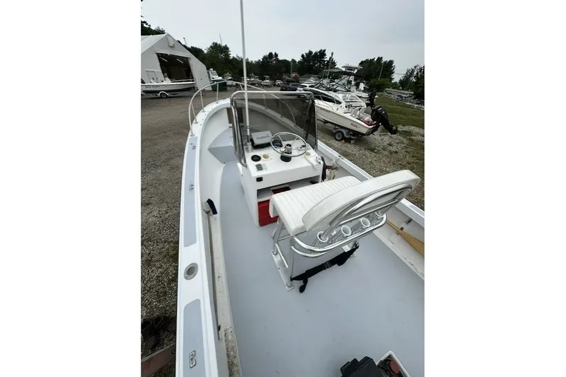 Slide: The Image of 1975 F L Tripp & Sons 18 Center Console boat with white seating and steering wheel. - 11