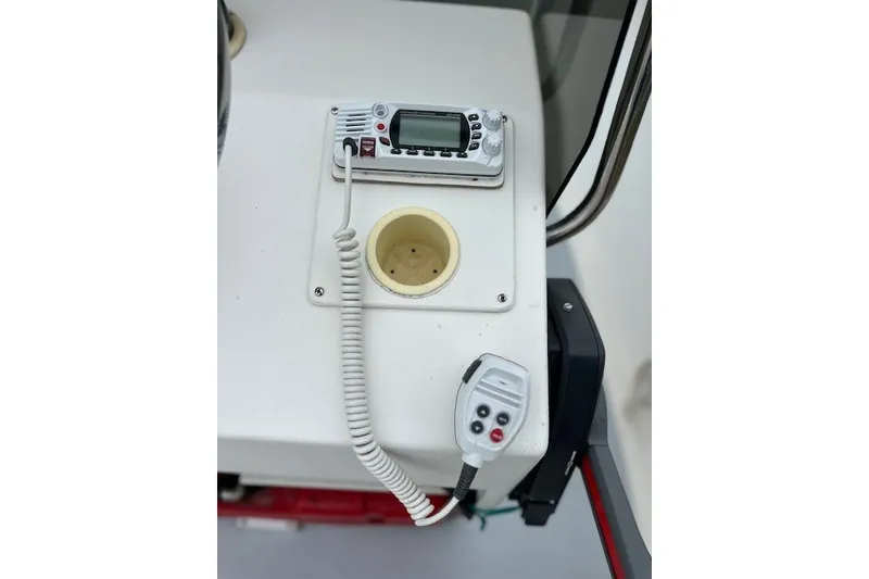 Slide: The Image of 1975 F L Tripp & Sons 18 Center Console boat dashboard with radio and controls. - 9