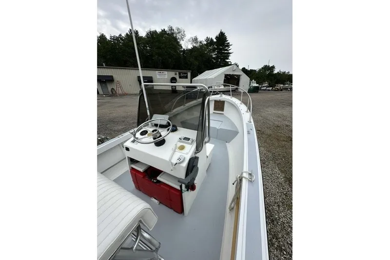 Slide: The Image of 1975 F L Tripp & Sons 18 Center Console boat with steering wheel and controls. - 13