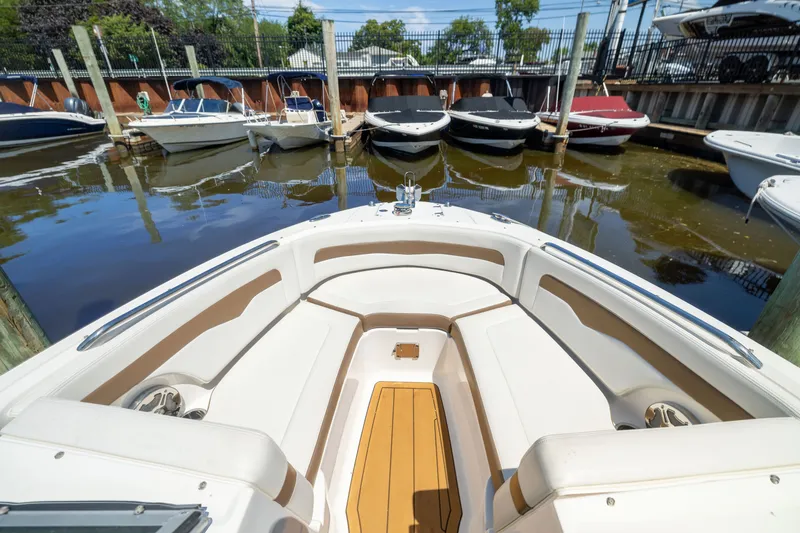Slide: The Image of 2015 Chaparral 246 SSi boat docked, featuring spacious seating and sleek design. - 18