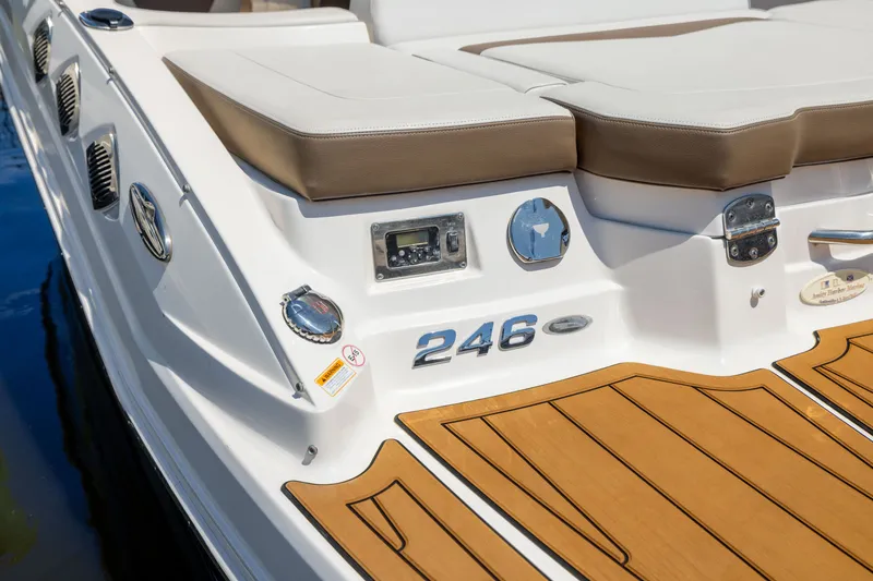 Slide: The Image of 2015 Chaparral 246 SSi boat with teak-style swim platform and cushioned seating. - 24