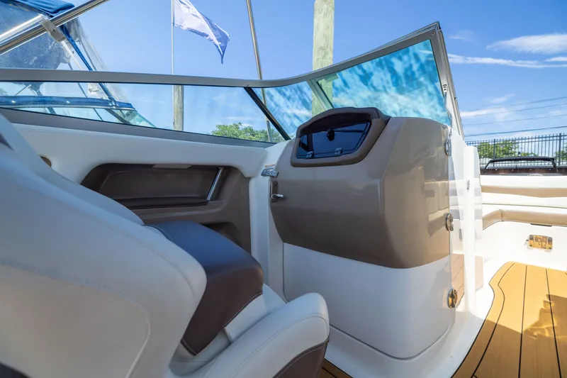 Slide: The Image of 2015 Chaparral 246 SSi boat interior with modern dashboard and seating. - 15