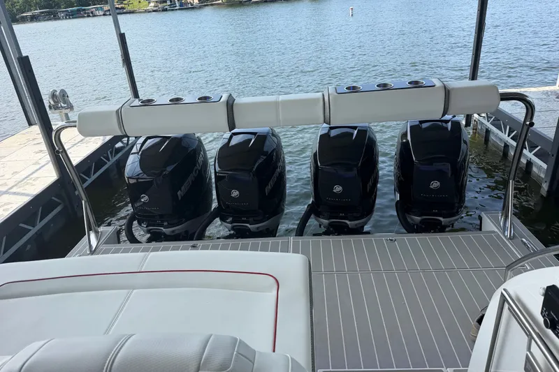 Slide: The Image of 2021 Formula 430 Super Sport Crossover with four Mercury outboard engines docked by the water. - 70