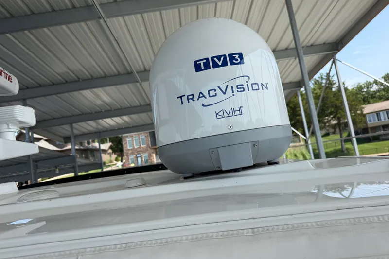 Slide: The Image of Satellite TV antenna on 2021 Formula 430 Super Sport Crossover boat under a covered dock. - 27