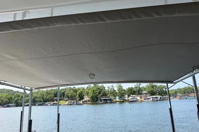 Slide: The Image of View from a 2021 Formula 430 Super Sport Crossover boat, overlooking a serene lakeside scene. - 43
