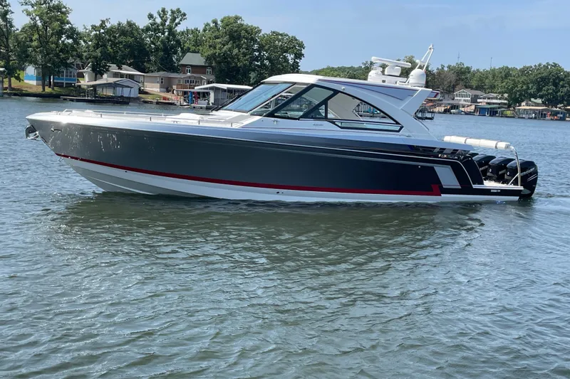 Slide: The Image of 2021 Formula 430 Super Sport Crossover boat on a calm lake. - 15