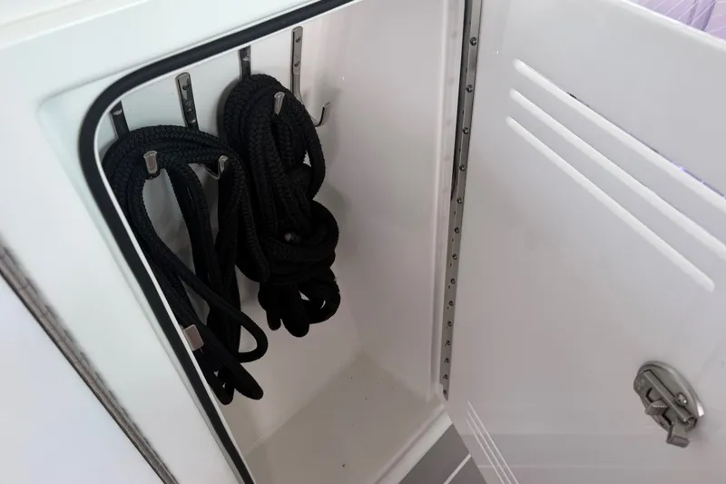 Slide: The Image of Storage compartment with black ropes in a 2021 Formula 430 Super Sport Crossover boat. - 60