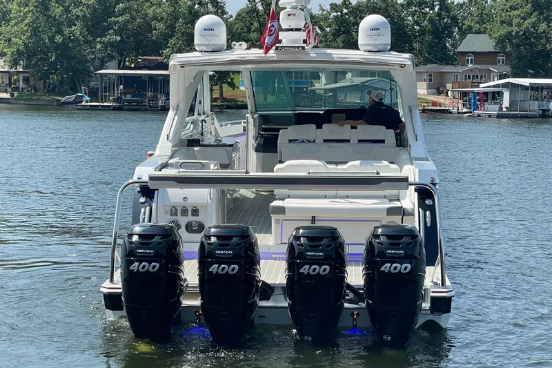 Slide: The Image of 2021 Formula 430 Super Sport Crossover with four powerful outboard engines on a serene lake. - 23