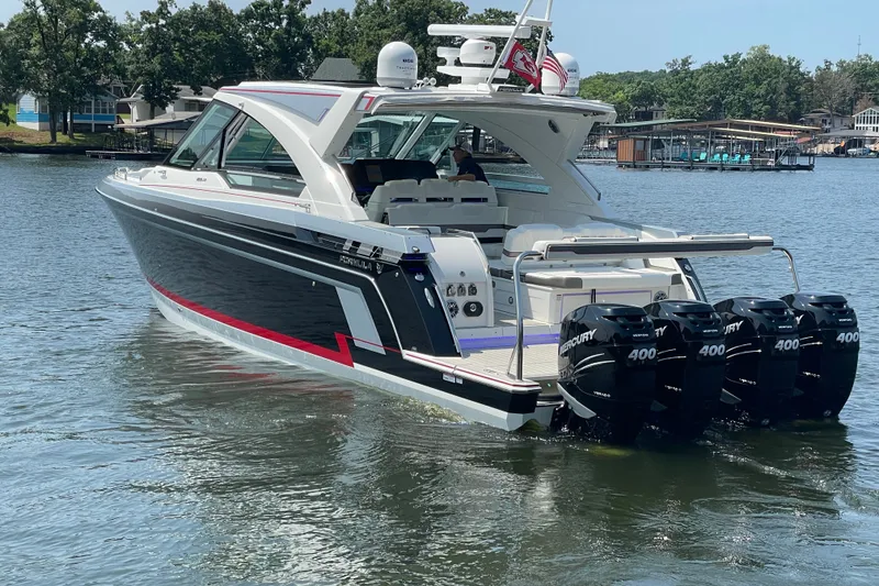 Slide: The Image of 2021 Formula 430 Super Sport Crossover boat with quad Mercury 400 engines on a lake. - 22