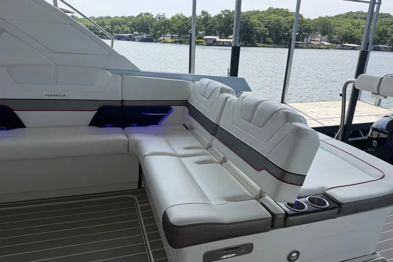 Slide: The Image of Luxury seating on 2021 Formula 430 Super Sport Crossover boat, docked by a serene lake. - 65