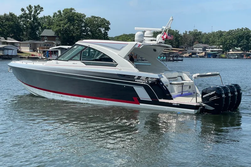 Slide: The Image of 2021 Formula 430 Super Sport Crossover boat on a lake with Mercury engines. - 19