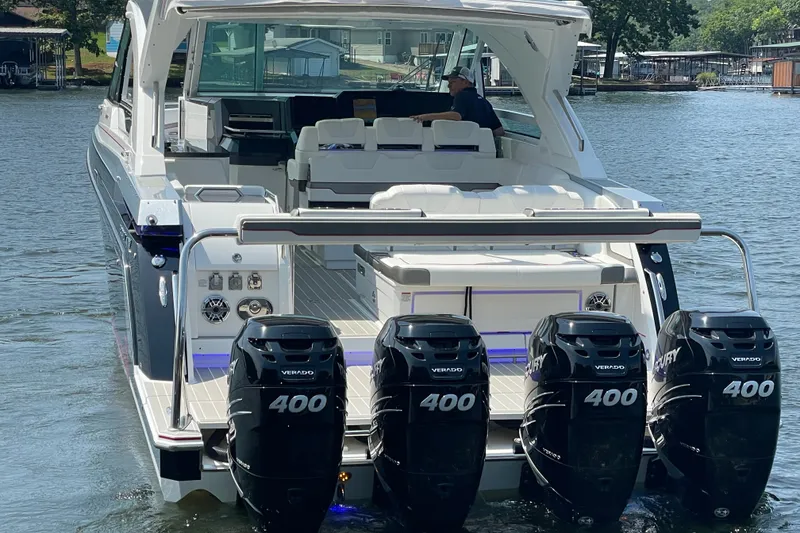 Slide: The Image of 2021 Formula 430 Super Sport Crossover boat with four powerful outboard engines on a lake. - 24