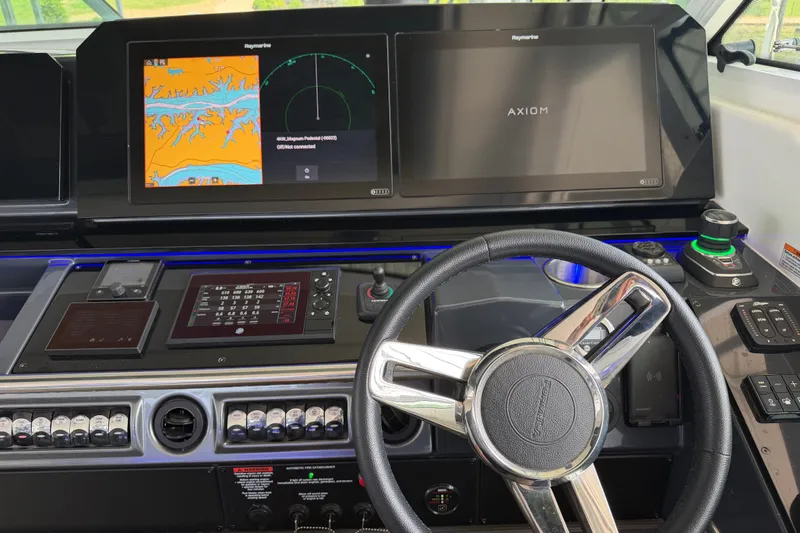 Slide: The Image of 2021 Formula 430 Super Sport Crossover dashboard with navigation screens and steering wheel. - 40