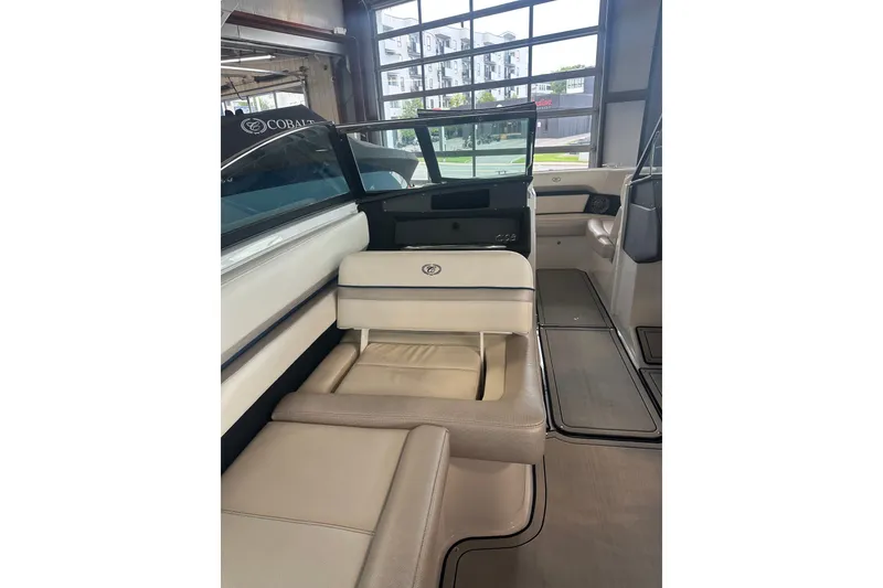 Slide: The Image of 2020 Cobalt CS23 Surf boat interior with beige seating and modern design. - 16