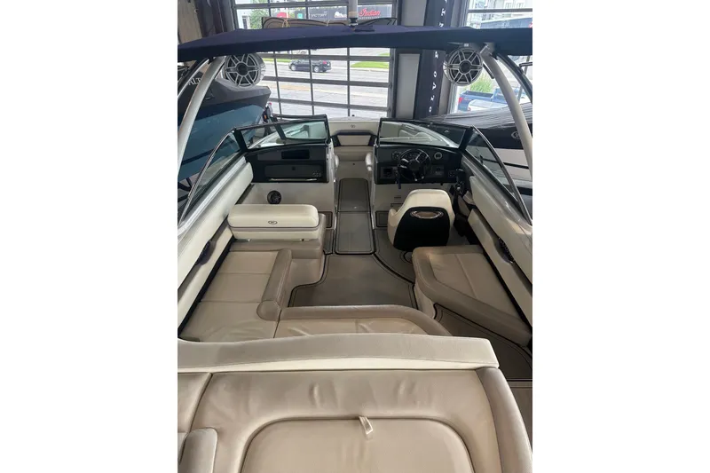Slide: The Image of 2020 Cobalt CS23 Surf boat interior with beige seating and modern dashboard. - 18