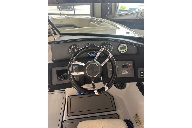 Slide: The Image of 2020 Cobalt CS23 Surf boat dashboard with steering wheel and control panel. - 15
