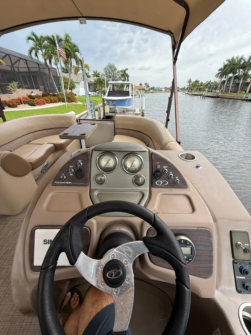 Slide: The Image of The image shows the cockpit of a 2018 Veranda VVF25F2 boat with a sleek steering area. - 9