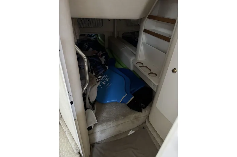 Slide: The Image of Interior cabin of 2000 Sea Ray 290 Sundancer with storage and seating area. - 14