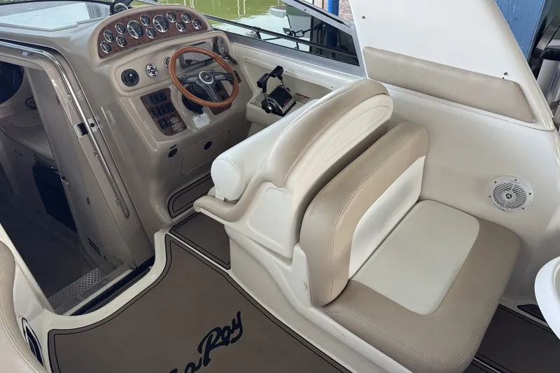 Slide: The Image of Interior of 2000 Sea Ray 290 Sundancer boat with steering wheel and seating. - 6