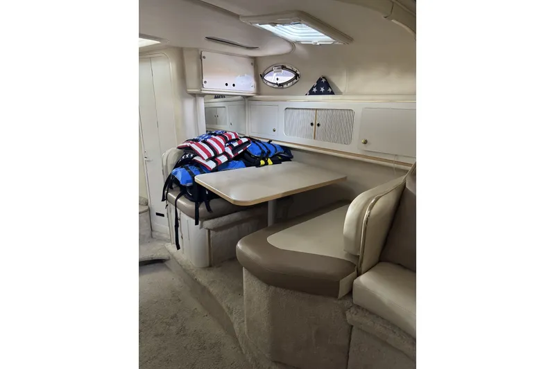 Slide: The Image of Interior of 2000 Sea Ray 290 Sundancer with seating and life jackets. - 11