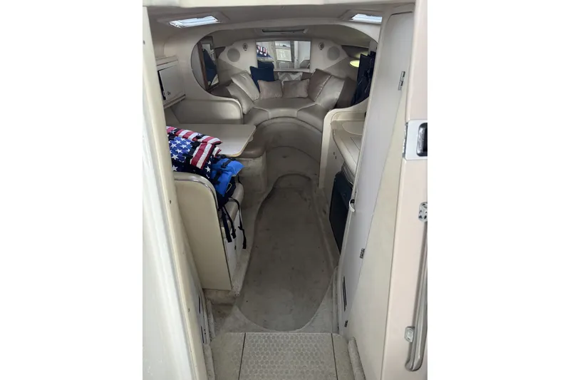 Slide: The Image of Interior of 2000 Sea Ray 290 Sundancer boat, featuring cozy seating and compact design. - 8